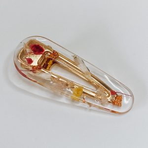 Barrette résine fleurs séchées et feuilles d’or.